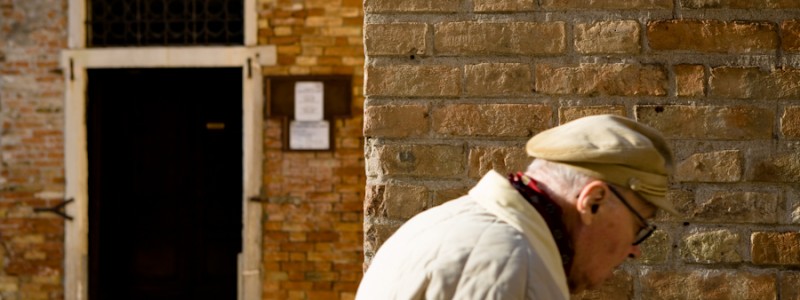 Venice, Italy - old man passing by, color photo