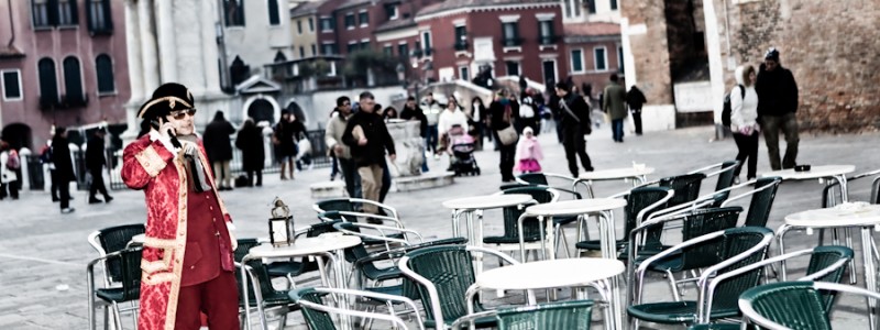Venice-gentleman dressed in 18th century costume on the cellphone in Venice, color landscape photo