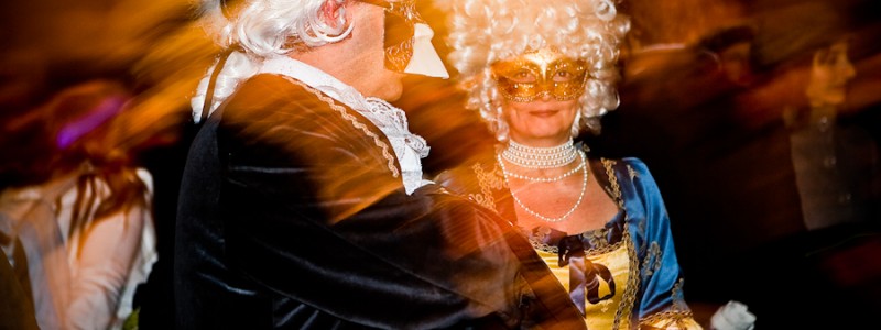 Venice-Couple dressed in costume for Carnival in St. Mark's square, color landscape photo