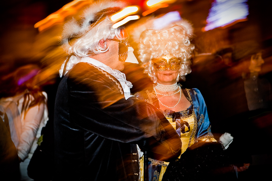 Venice-Couple dressed in costume for Carnival in St. Mark's square, color landscape photo