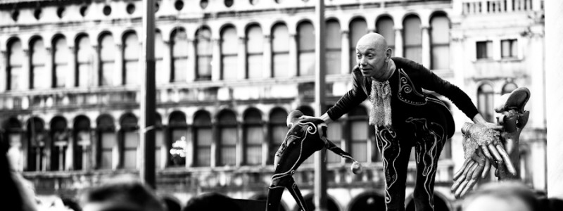 Venice-Actor in carnival costume in St. Mark's square, color landscape photo