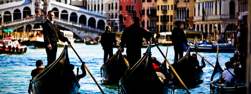 Venice, Italy - gondolas in Grand Canal nearby Rialto Bridge, color photo