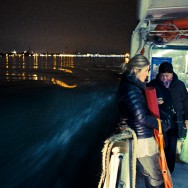 Venice - night photo on a waterbus with St. Mark's lights in background, color landscape photo