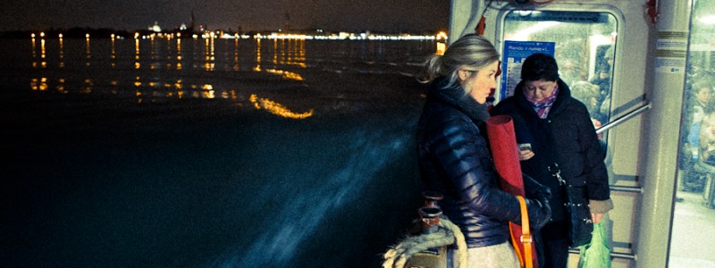 Venice - night photo on a waterbus with St. Mark's lights in background, color landscape photo