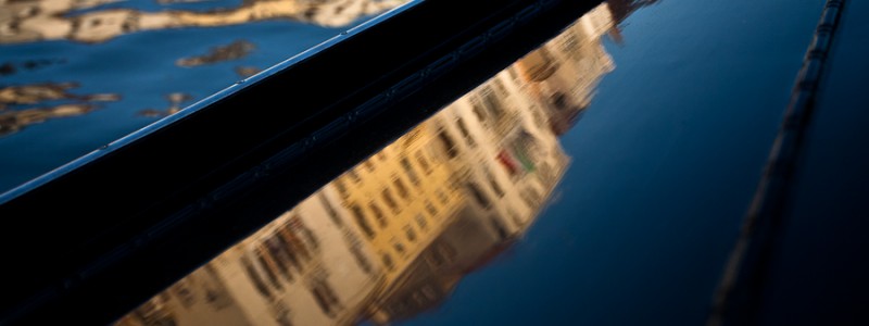 Venice - reflections of Grand Canal palaces over the side of a gondola , color landscape photo