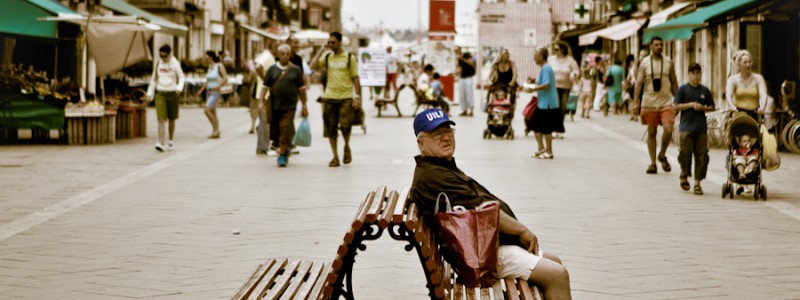 Venice - old man sitting on a bench in Via Garibaldi, color landscape photo