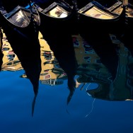 Venice - moored gondolas reflect on the water, landscape color photo