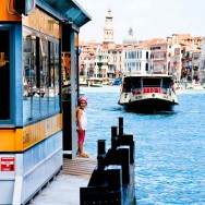 Venice - little girl waiting for the waterbus in Grand Canal, color landscape photo