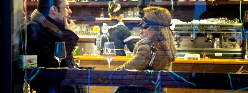 Venice-couple chatting at the cafè during Carnival, color landscape photo